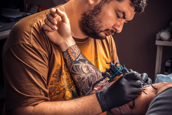 Tattooer posing in tattoo studio