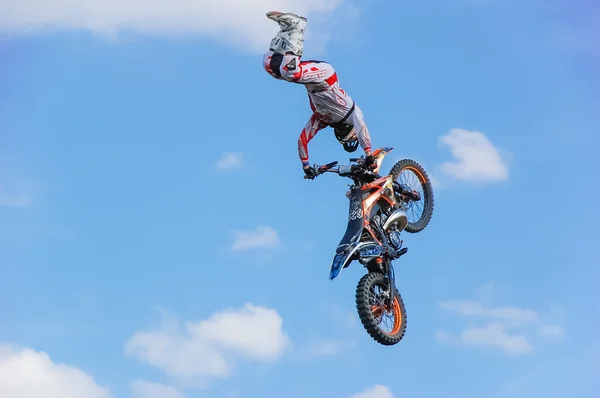 PENZA, RUSSIA - JUNE 18, 2011: Motocross Rider Jump in a blue sky with clouds
