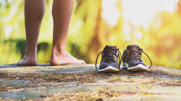 Young male cross country runner, legs and shoes detail