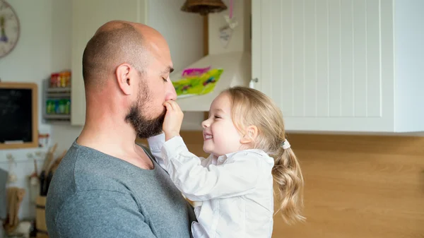 Father and daughter in the kitchen, fathers day concept, real family