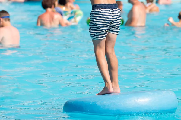 Child in swimming pool. Aqua park summer vacation concept
