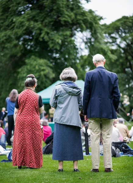 Older generation, seniors, enjoying an outdoors music, culture, community event, festival.