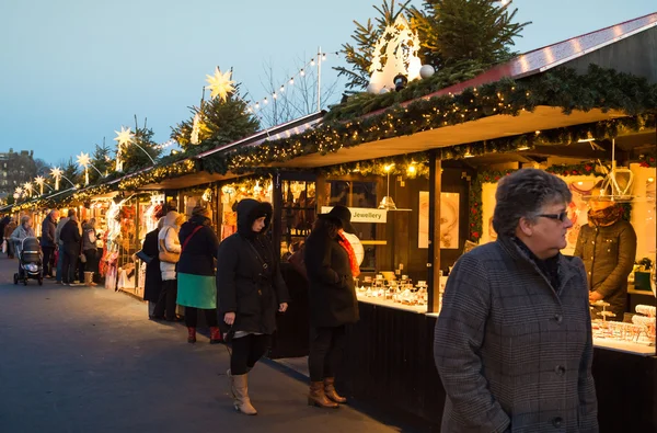 EDINBURGH, SCOTLAND, UK, December 08, 2014 - People walking among german christmas market stalls in Edinburgh, Scotland, UK