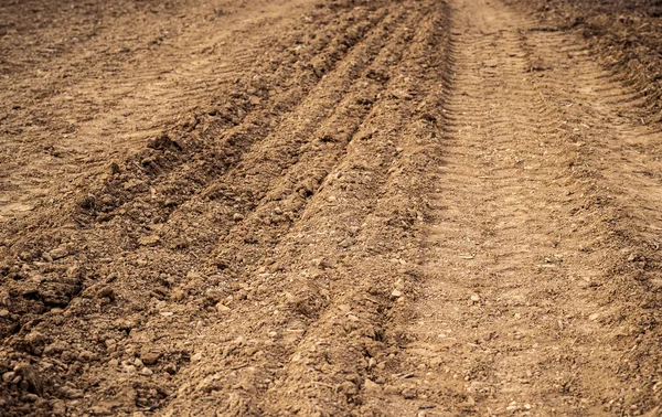 Ploughed field, soil close up, agricultural background