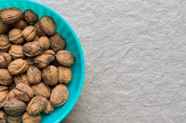 Pile of organic walnuts in a bowl, close up, clean eating concept