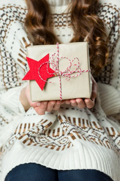 Anonymous woman holding beautifuly wrapped present, xmas concept