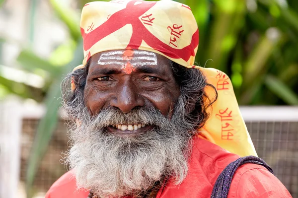 Goa, India - January 2008 - Smiling portrait of an Indian sadhu, holy man, with traditional painted face