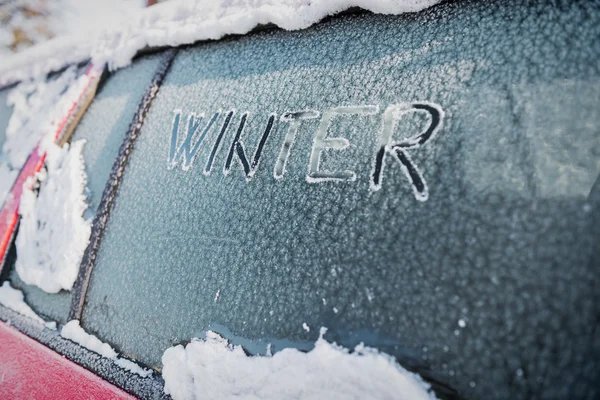 Frozen car window, car parked outside, winter transport issues
