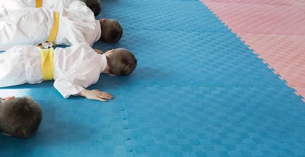 A boy in kimono pushing-ups from the tatami