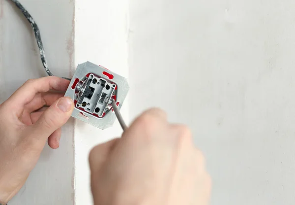 Electrician Hands With Screwdriver Installing Wall Socket