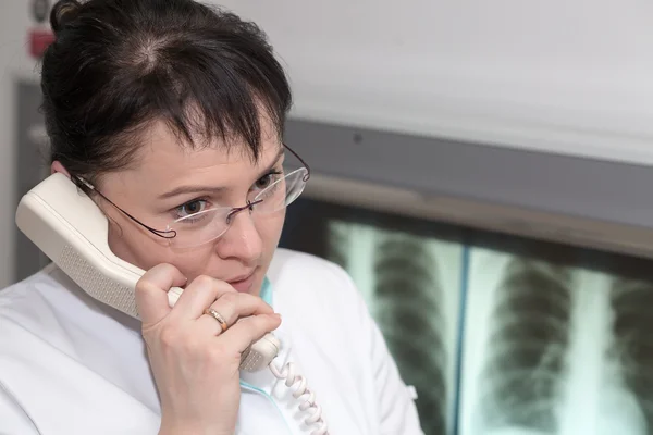 Female radiologist doctor talking on a phone