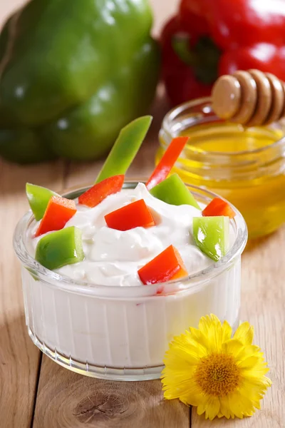 Yogurt with sweet pepper on the table. Light breakfast.