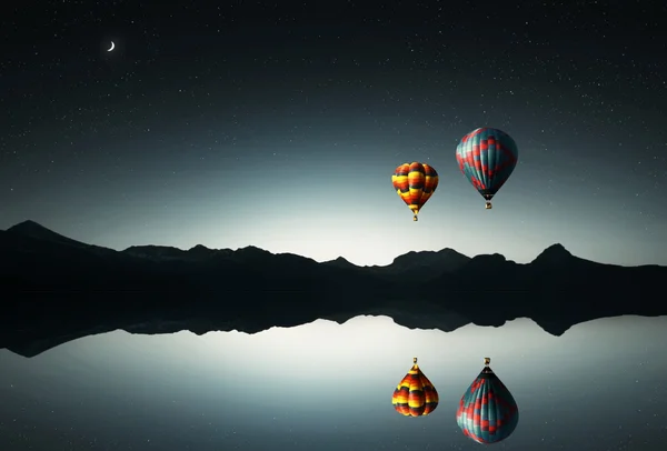 Balloons flying ver the water