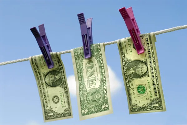 US one dollar bills hanging out to dry, money laundering concept