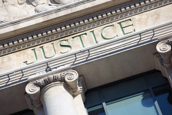 Justice sign on a Courthouse Building.