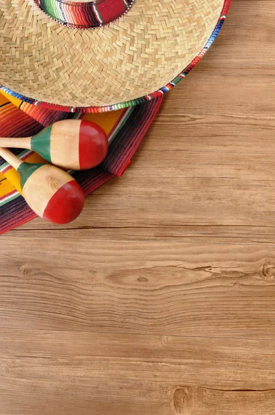 Mexican sombrero and blanket on pine wood floor