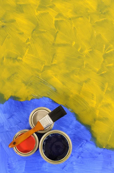 Yellow and blue paint with paint tins