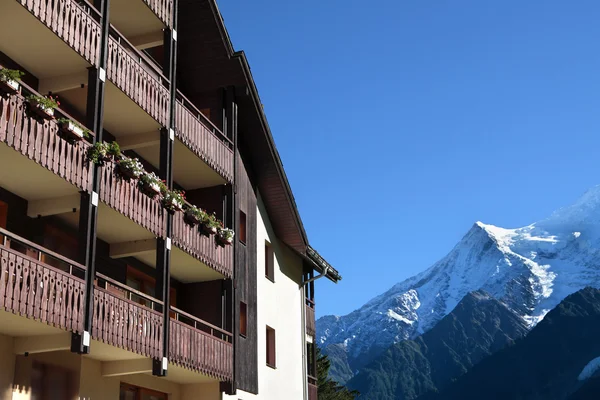 Ski resort vacation chalet hotel, European alps in distance