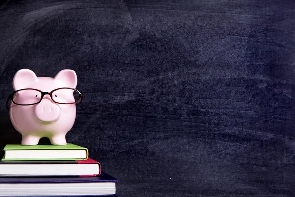 Piggy bank with glasses and blackboard