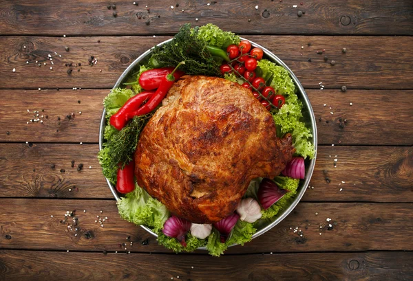 Roasted pork shoulder with vegetables, meat dish