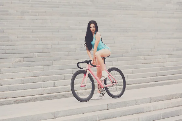 Young slim sexy sportive woman on bicycle