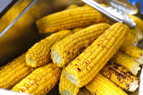 Fresh corncobs cooked at barbecue grill