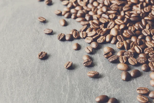 Coffee beans on stone with copy space, background