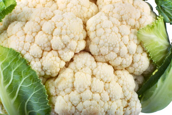 Fresh ripe cauliflower with green leaves isolated on white