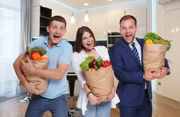 Happy people hold bags with healthy food, grocery buyers isolated
