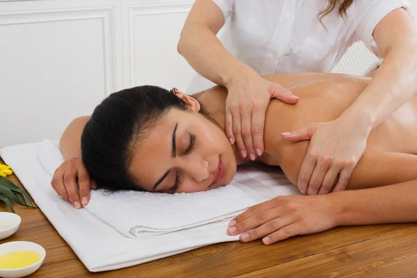 Woman massagist make body massage in spa wellness center