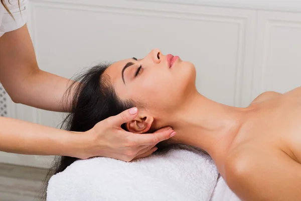 Woman beautician doctor make neck massage in spa wellness center