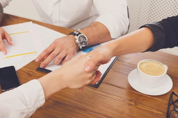 Business handshake closeup at office meeting, contract conclusion