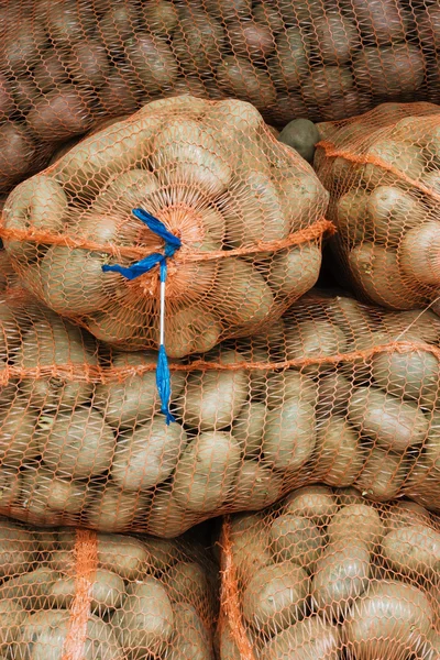Net sacks with potatoes in the food store