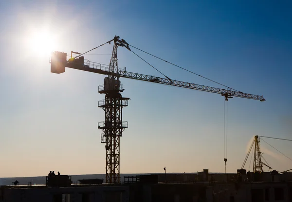 Tower crane silhouette at construction area