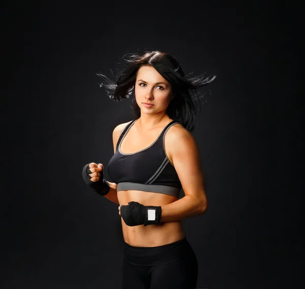 Young fitness woman in gym gloves