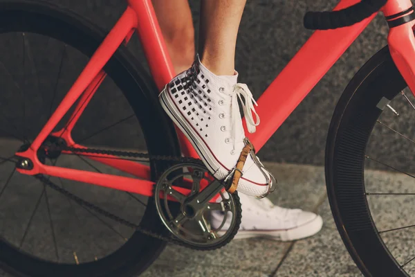 Young woman foot at bicycle pedal closeup