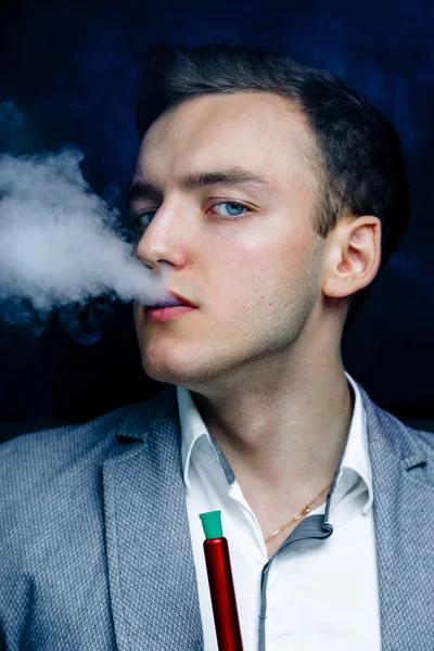 Man in blue suit smoking hookah