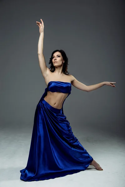 Woman dancer wearing blue skirt