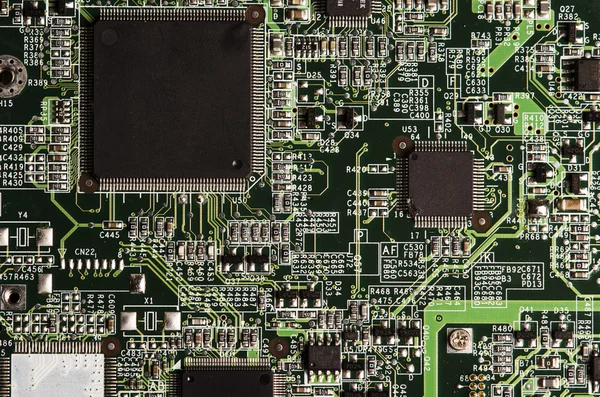 Electronic circuit board with processor in black and green.