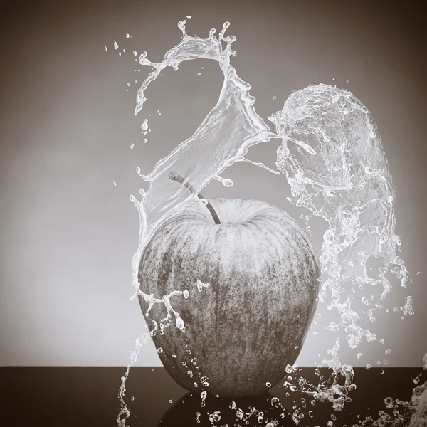 Black and white apple splashed by water on a black and white background.