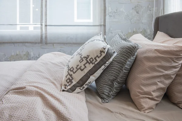 Single bed with row of pillows