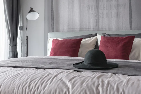 Black hat on bed in modern bedroom design