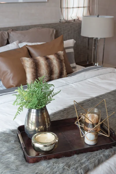 Wooden tray of plant in modern bedroom with white lamp on wooden