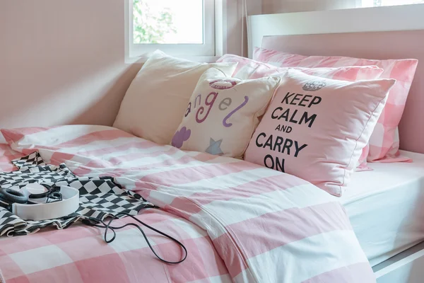 Pink color tone bedroom design with pink pillows