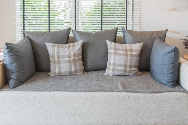 Set of pillows on modern sofa in modern living room