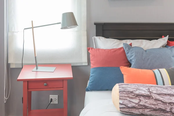 Colorful pillows on bed in single bedroom design