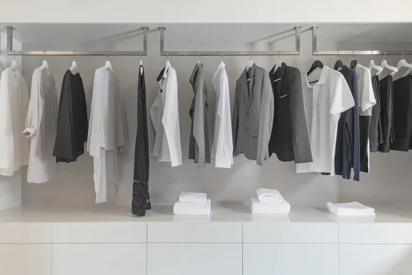 Black and white color tone clothes hanging on rail