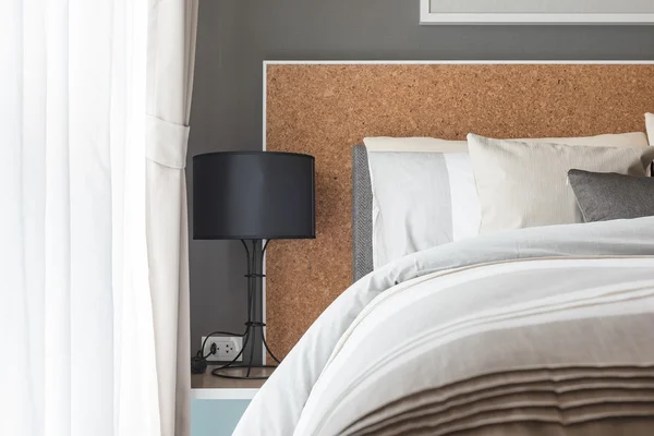 Modern black lamp on table side in modern bedroom