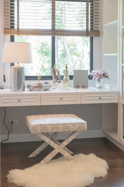 White dressing table and chair with women\'s accesories