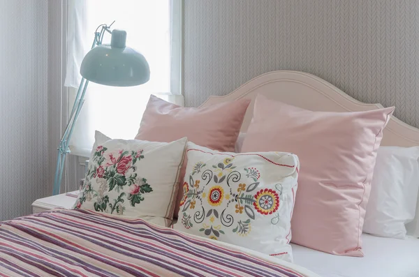 Pink pillows on bed in bedroom